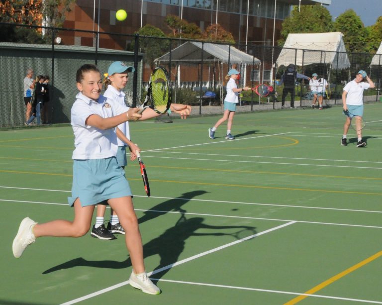 student-hitting-ball-on-tennis-court