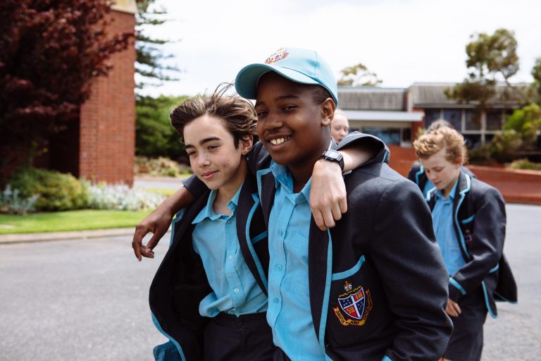 two-students-smiling-together-with-arms-around-shoulders