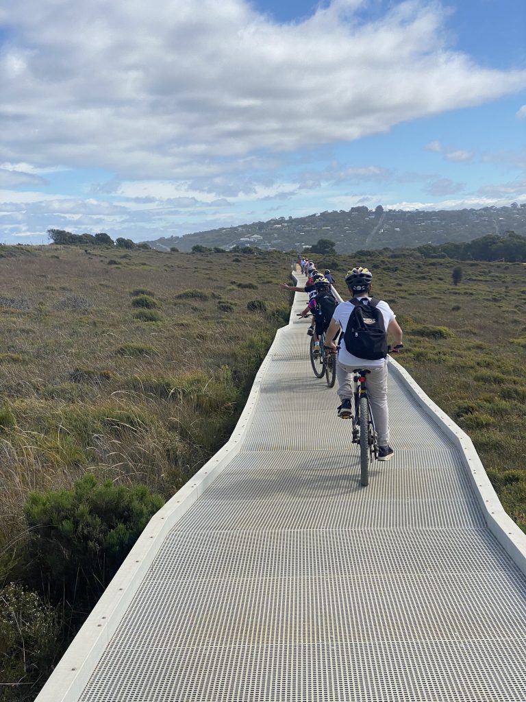students-cycling-on-trail